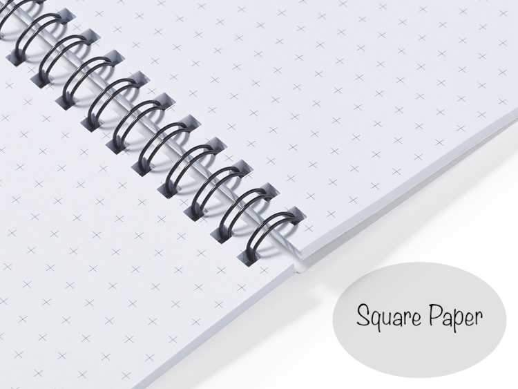 A close up of an open notebook showing paper with squares on it