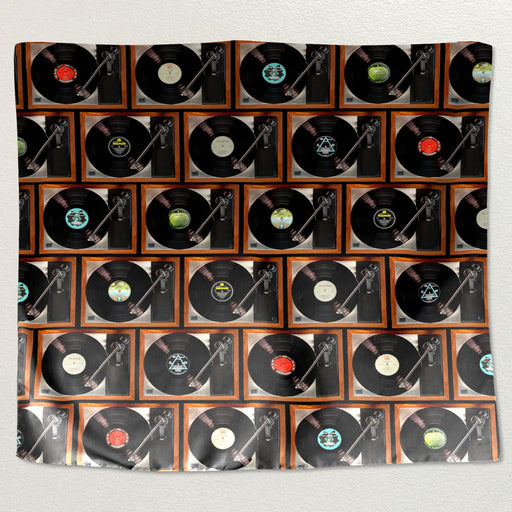 A montage of record players printed on a tapestry wall hanging fabric, each record player with different vinyl records, the tapestry hung on a white wall