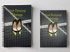 Two notebooks, side by side, both having covers with an image of a pair of yellow and black high heel shoes hanging from a tennis net and a personal message on the cover