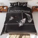 a duvet cover on a bed, the duvet having an image of a spilt cocktail on a kitchen floor along side a pair of silver high heel shoes, along with a personal message on the duvet