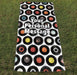 a towel with image of 7 inch vinyl records in a mosaic pattern with a personal message printed, the towel laid out on grass