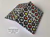 An open hardback notebook the cover having a print of a mosaic of seven inch vinyl records on a white background with a personal message printed on the book