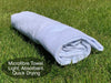 a rolled white towel laying on grass