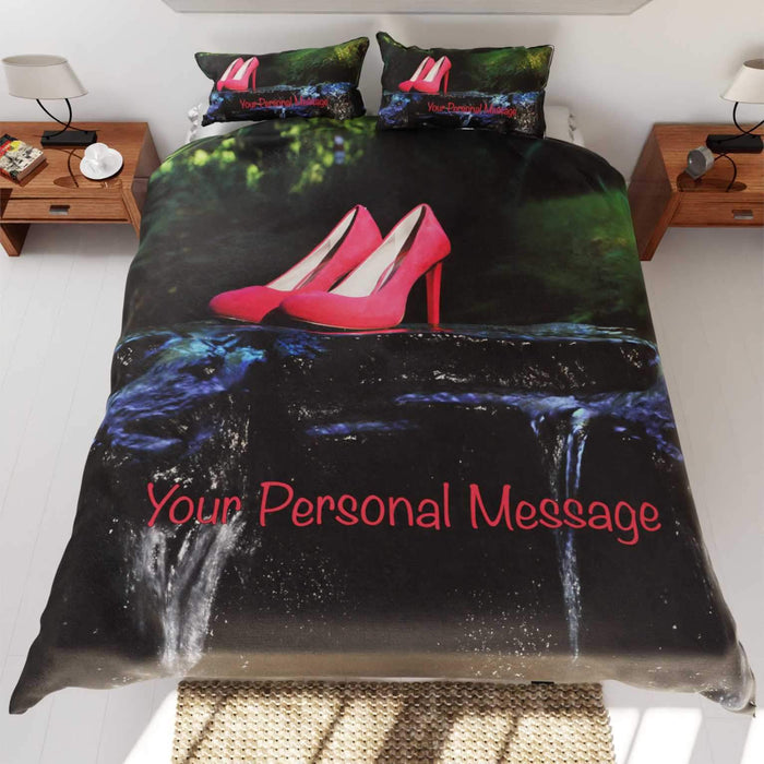a duvet and pillow set on a bed, the duvet and pillow having an image of a pair of pink high heels standing in a shallow flowing river with a personal message printed